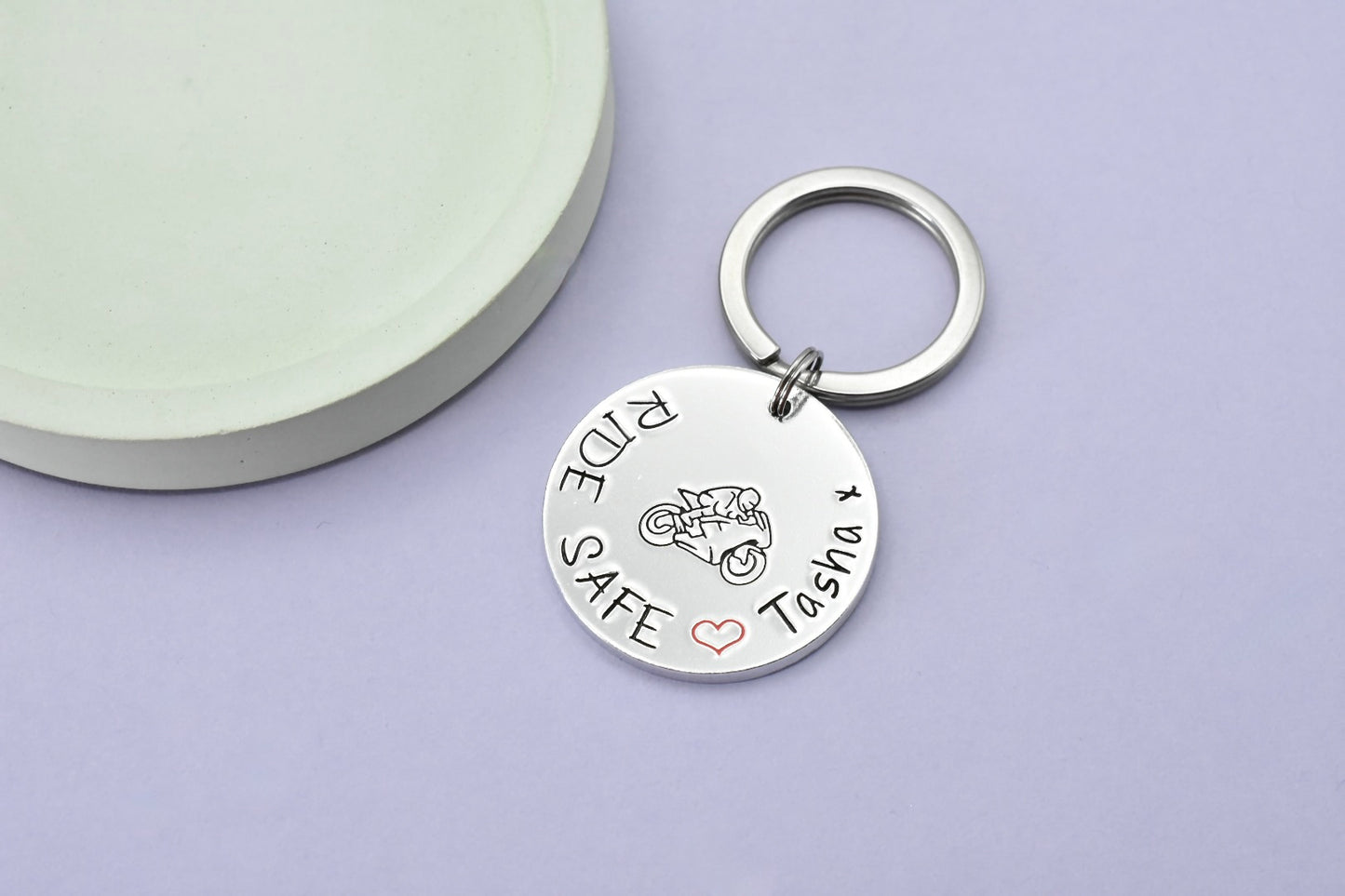 A personalized keyring with the inscription 'RIDE SAFE' on a split ring, personalised with name after a red heart design