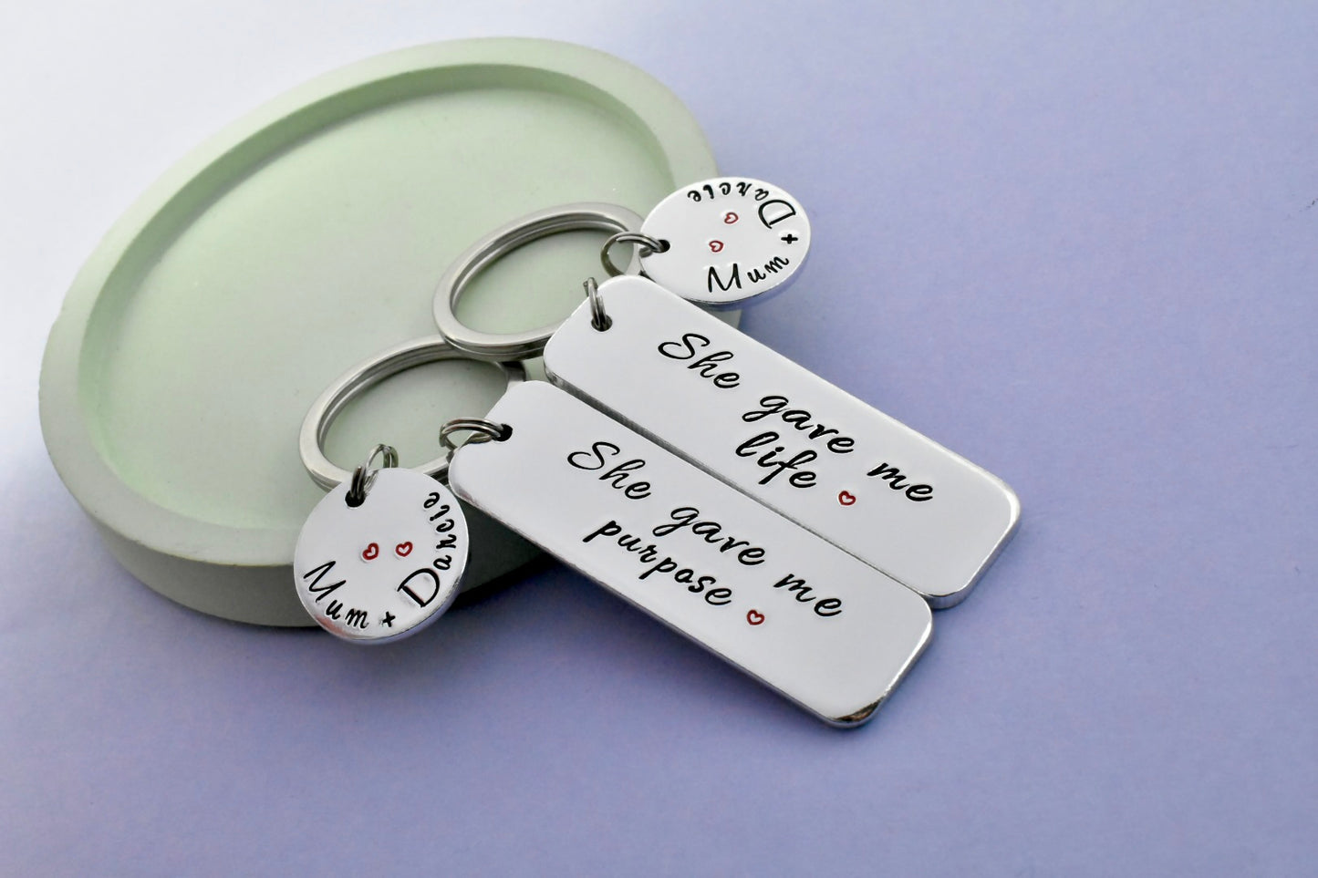 Personalised mum and child keyrings set with “She gave me life” and “She gave me purpose” quotes and custom name discs, handmade in the UK
