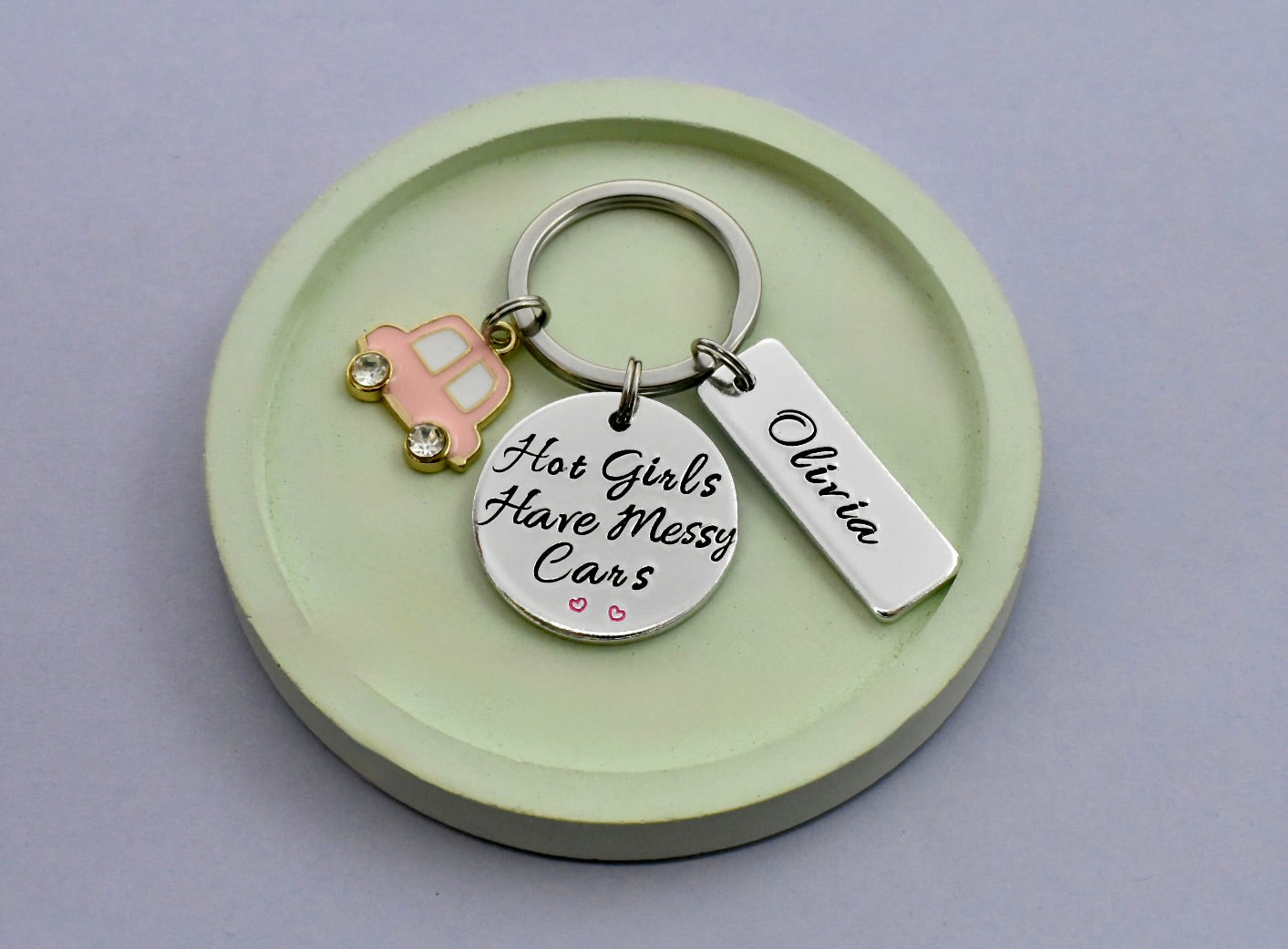 Keychain with 'Hot Girls Have Messy Cars' and 'Olivia' on persoanlsied tag, with pink car charm