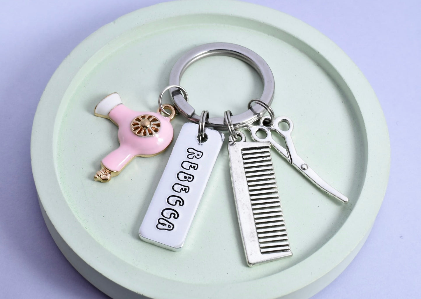 Silver aluminium hairdressing keyring. Personalised rectangle tag, comb, scissors and pink hairdryer charms
