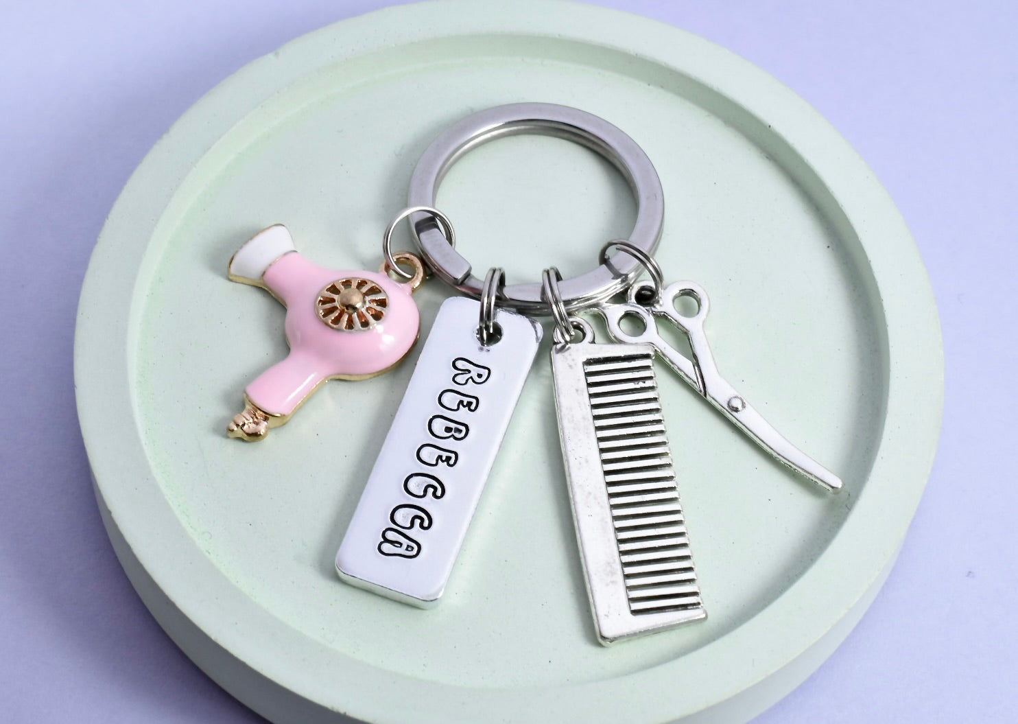 Silver aluminium hairdressing keyring. Personalised rectangle tag, comb, scissors and pink hairdryer charms