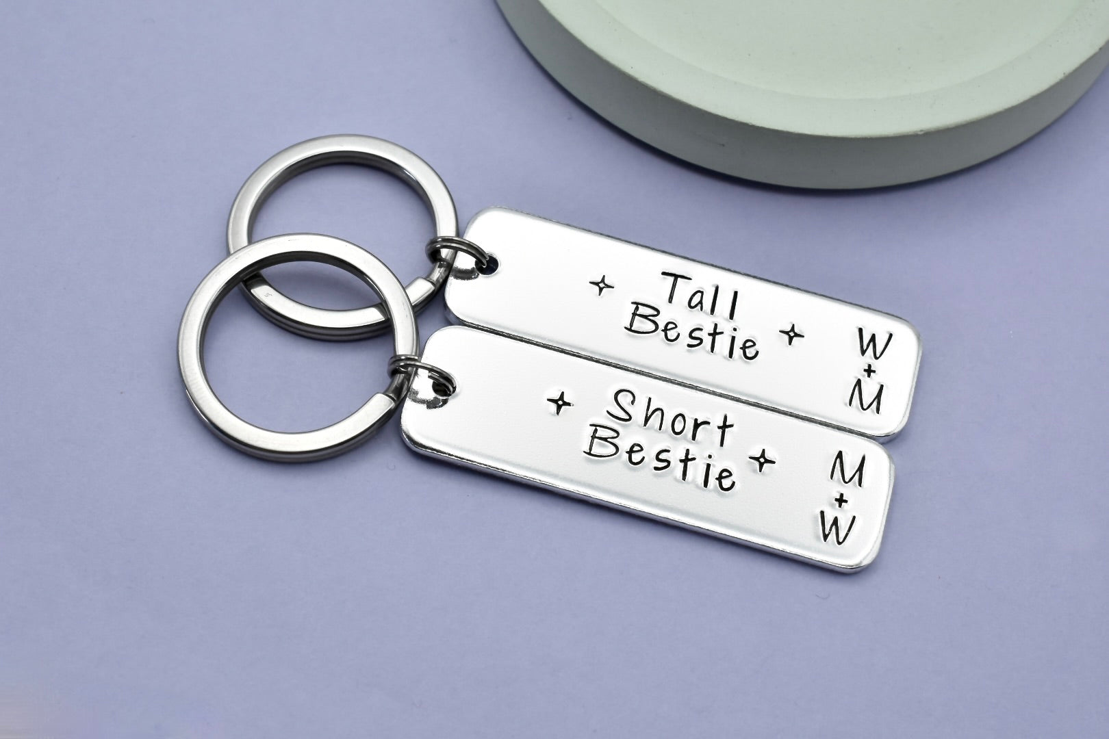Two aluminium keyrings, one engraved with 'Tall Bestie' and the other with 'Short Bestie'. Each keyring has two initials.