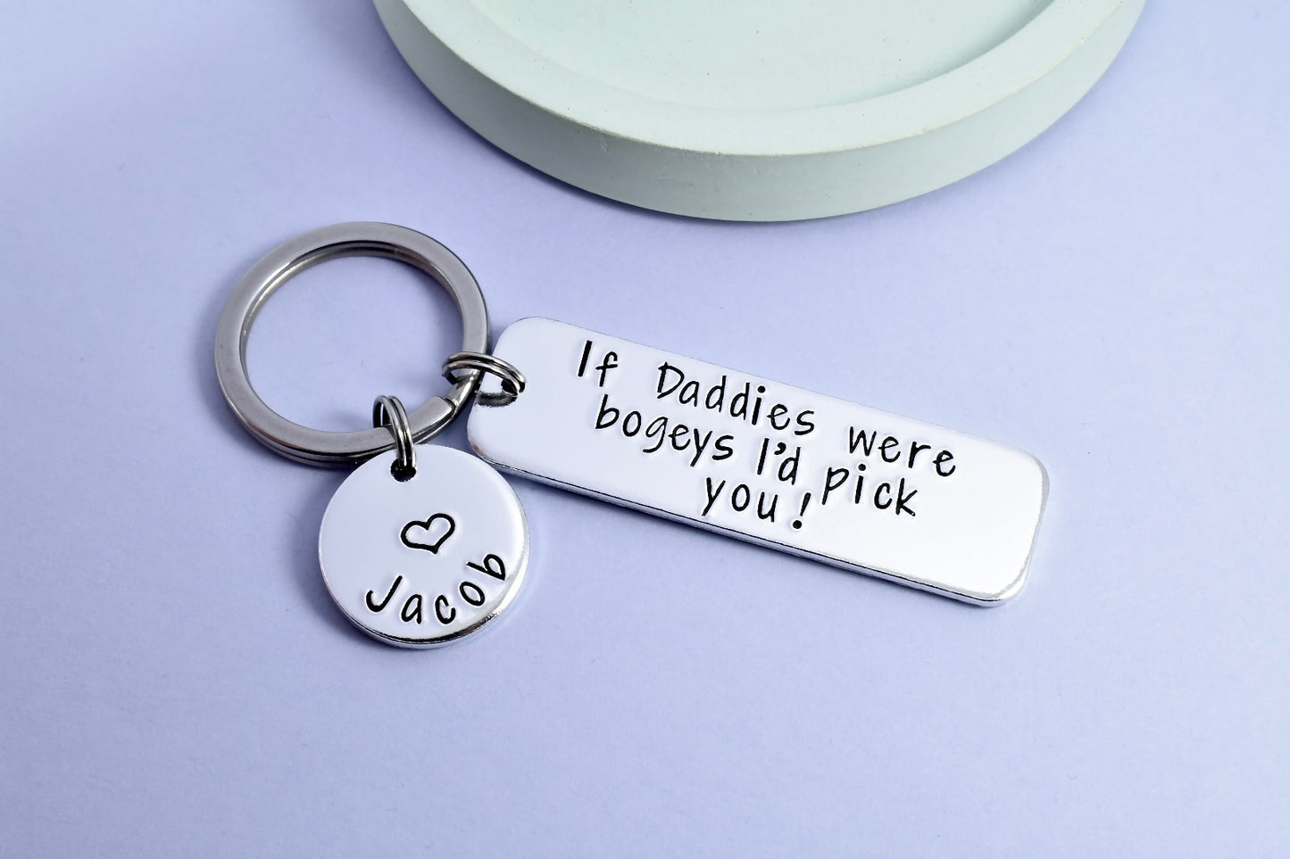 RECTANGULAR KEYRING WITH THE WORDING ON IT OF IF DADDIES WERE BOGEYS I'D PICK YOU! SMALLER DISC IS ALSO ATTACHED THAT HAS A CHILDS NAME PERSONALISED ONTO IT WITH A HEART
