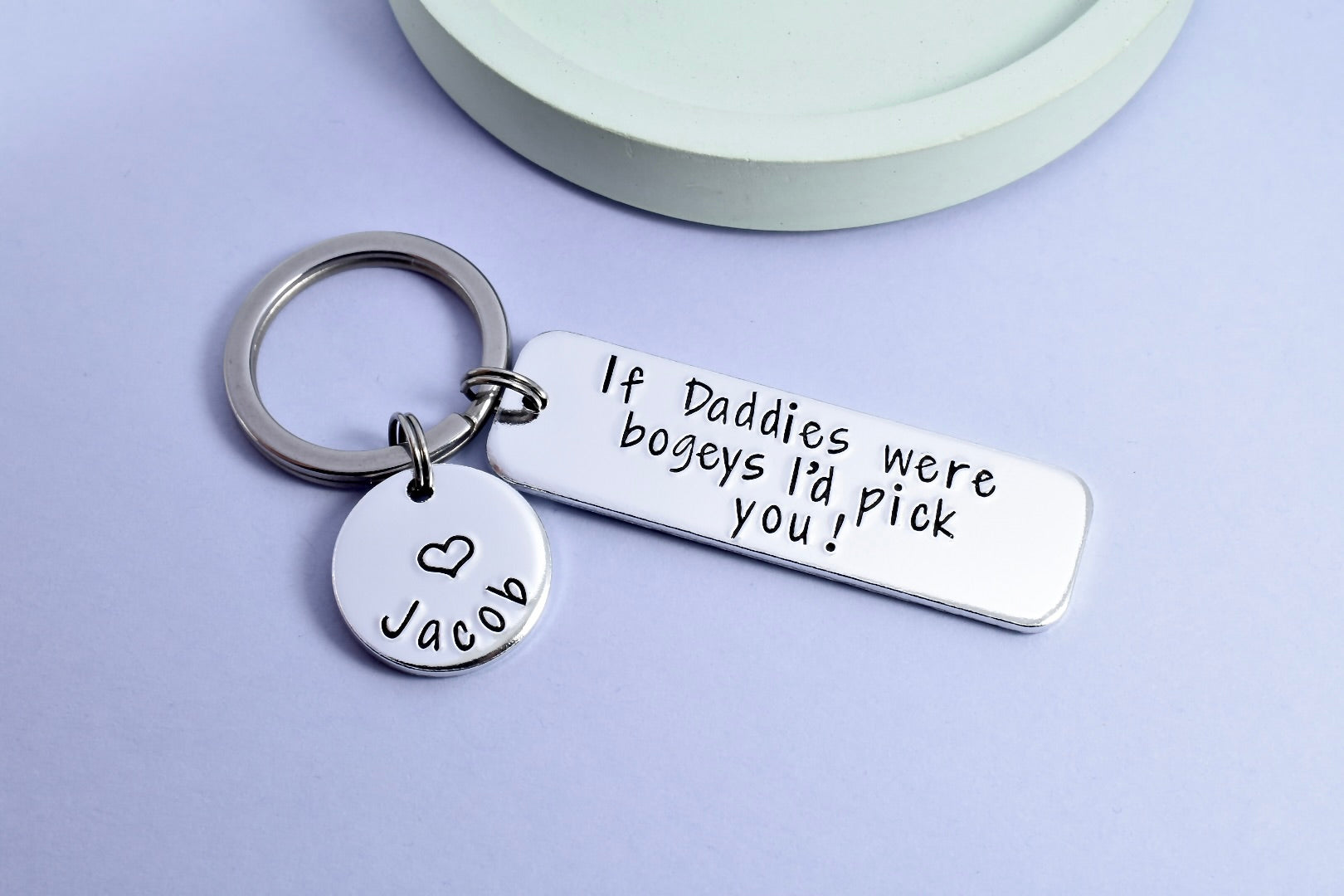 RECTANGULAR KEYRING WITH THE WORDING ON IT OF IF DADDIES WERE BOGEYS I'D PICK YOU! SMALLER DISC IS ALSO ATTACHED THAT HAS A CHILDS NAME PERSONALISED ONTO IT WITH A HEART