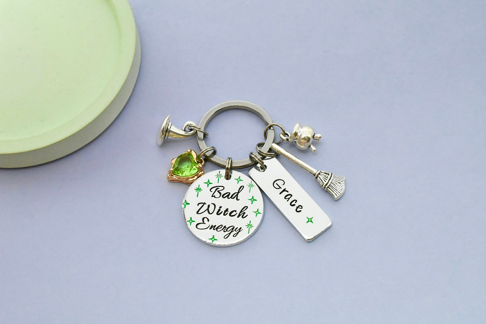 Keychain with 'Bad Witch Energy' and 'Grace' charms with green crystal charm
