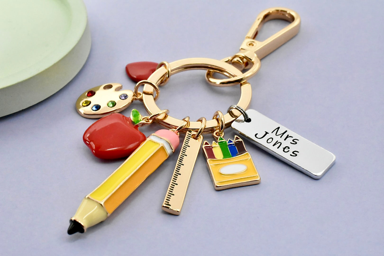 Keychain with educational-themed charms on a light gray background