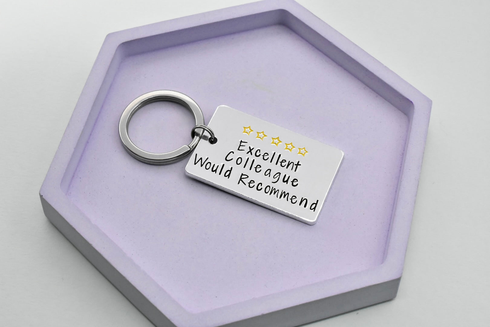 Silver rectangle keyring, stamped with 5 yellow stars at the top, with the text "Excellent Colleague Would Recommend" below