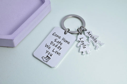 Forces Keyring. Silver rectangle reads "come home safe Daddy, we love you" with combat boot design, small girl and boy shaped tags are personalised with children's names