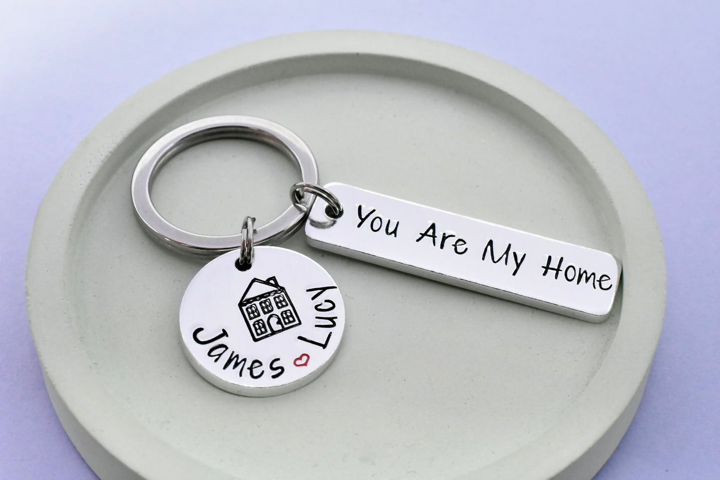 Rectanlge keychain with 'You Are My Home' hand stamped tag and small disc with personalised couple's names separated with red heart