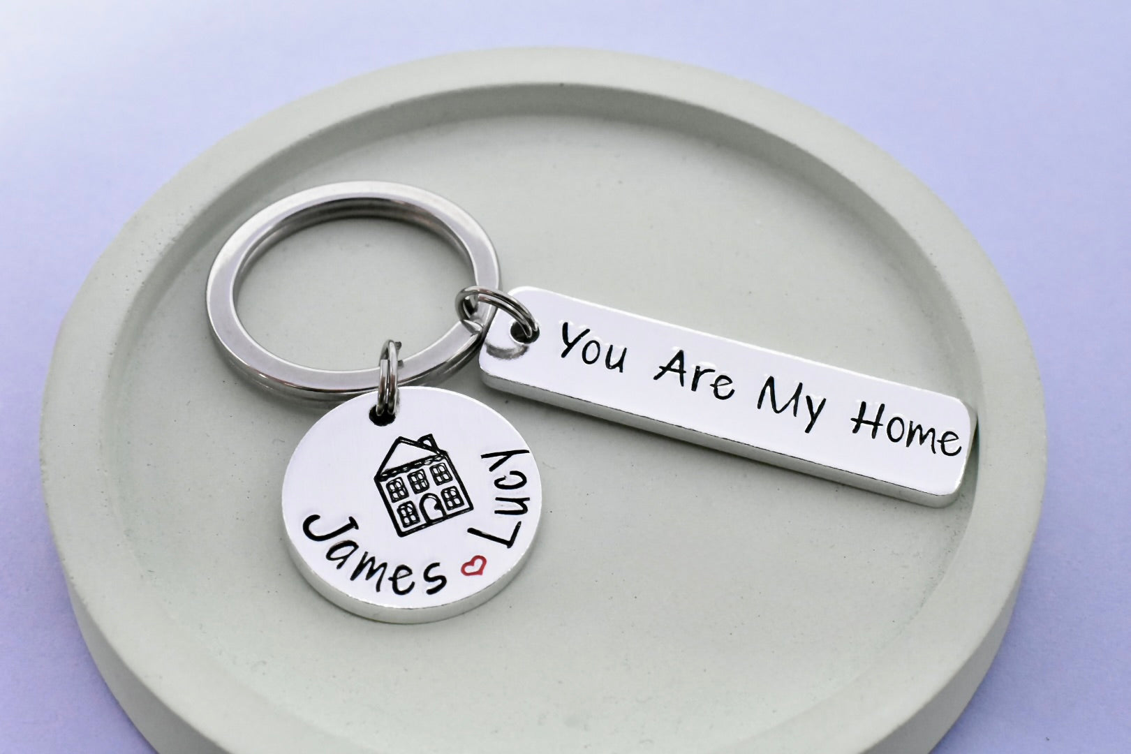 Rectanlge keychain with 'You Are My Home' hand stamped tag and small disc with personalised couple's names separated with red heart