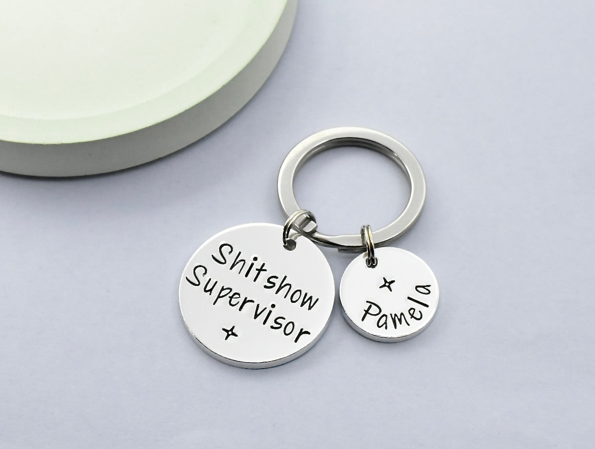 Aluminium 2 disc keyring, larger disc stamped with "Shitshow Supervisor" with star design and smaller disc personalised with name and small star design