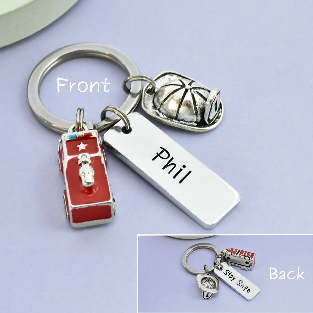 Keychain with various fire service charms and a name tag on a light purple background