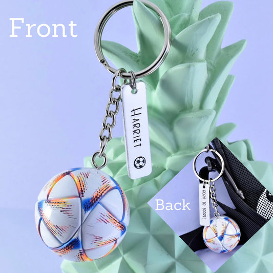 A personalised football keyring with a multicolored spherical charm representing a football and a rectangular tag with the name 'Harriet'. The keyring is displayed in front of and behind views, showing the personalisation on the front tag with back of the tag saying "born to score!'