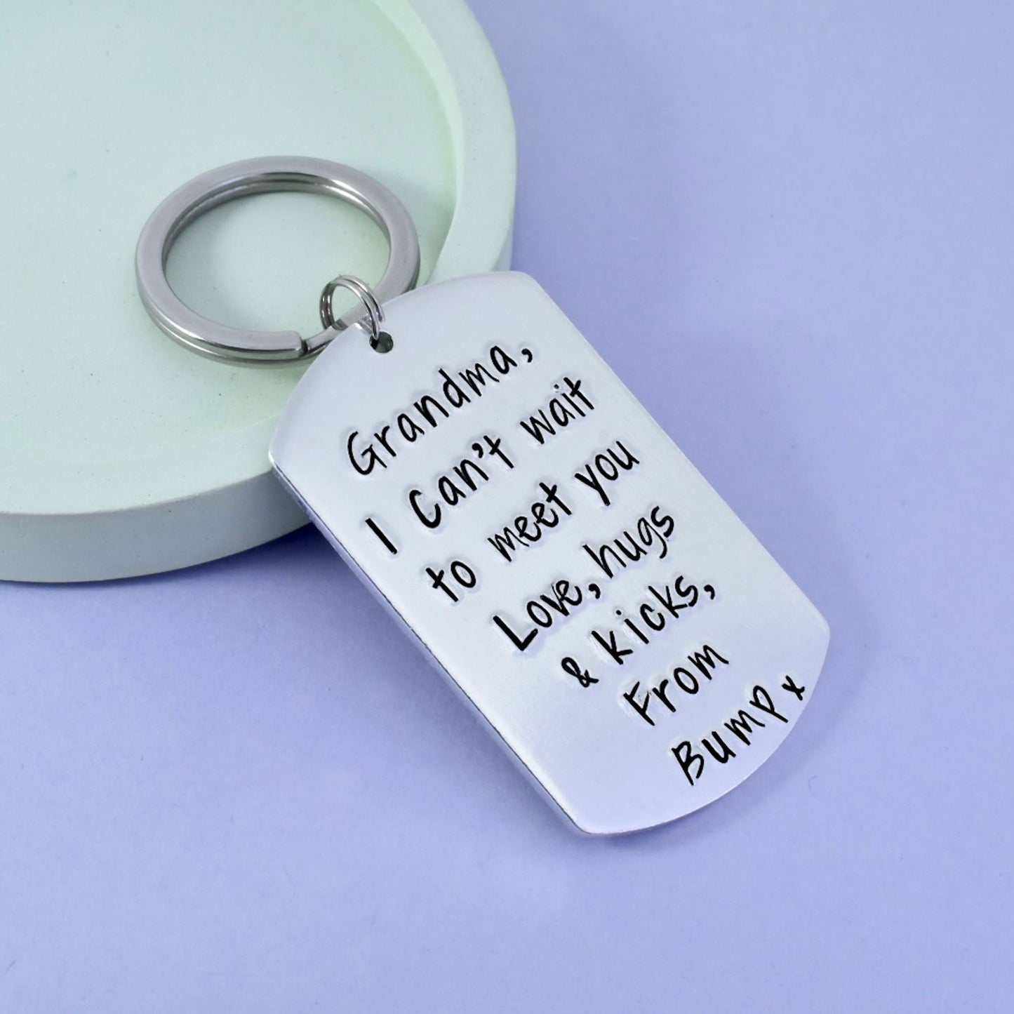 A silver keyring with a personalized message attached to it