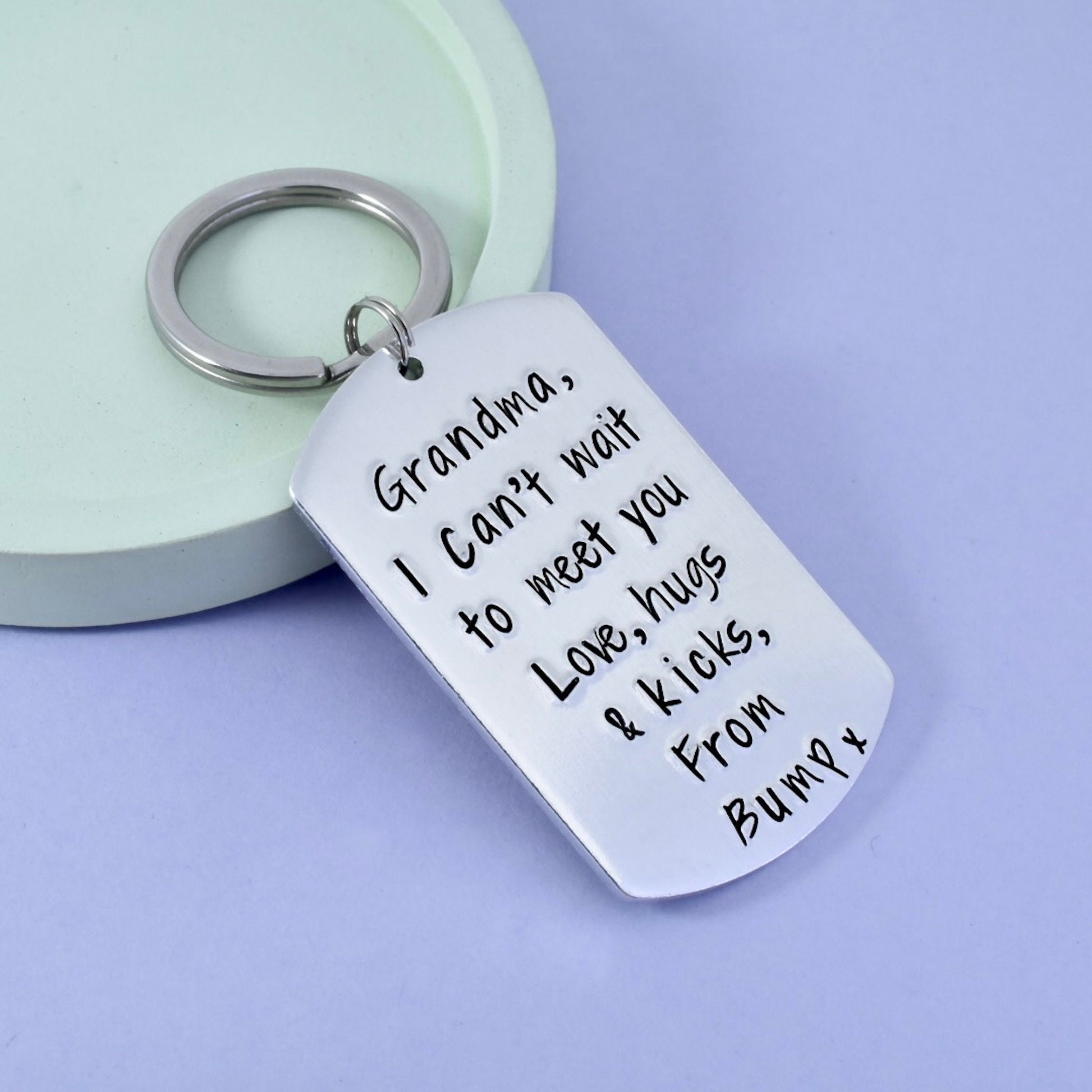 A silver keyring with a personalized message attached to it