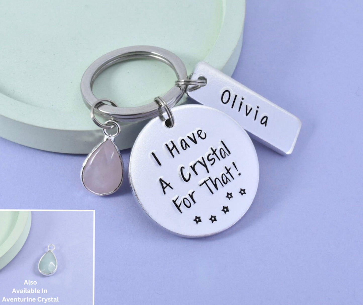 A personalised keyring with an aluminium disc stamped with the phrase 'I HAVE A CRYSTAL FOR THAT!' and a smaller rectangle disc with a name. It is accompanied by a crystal charm.