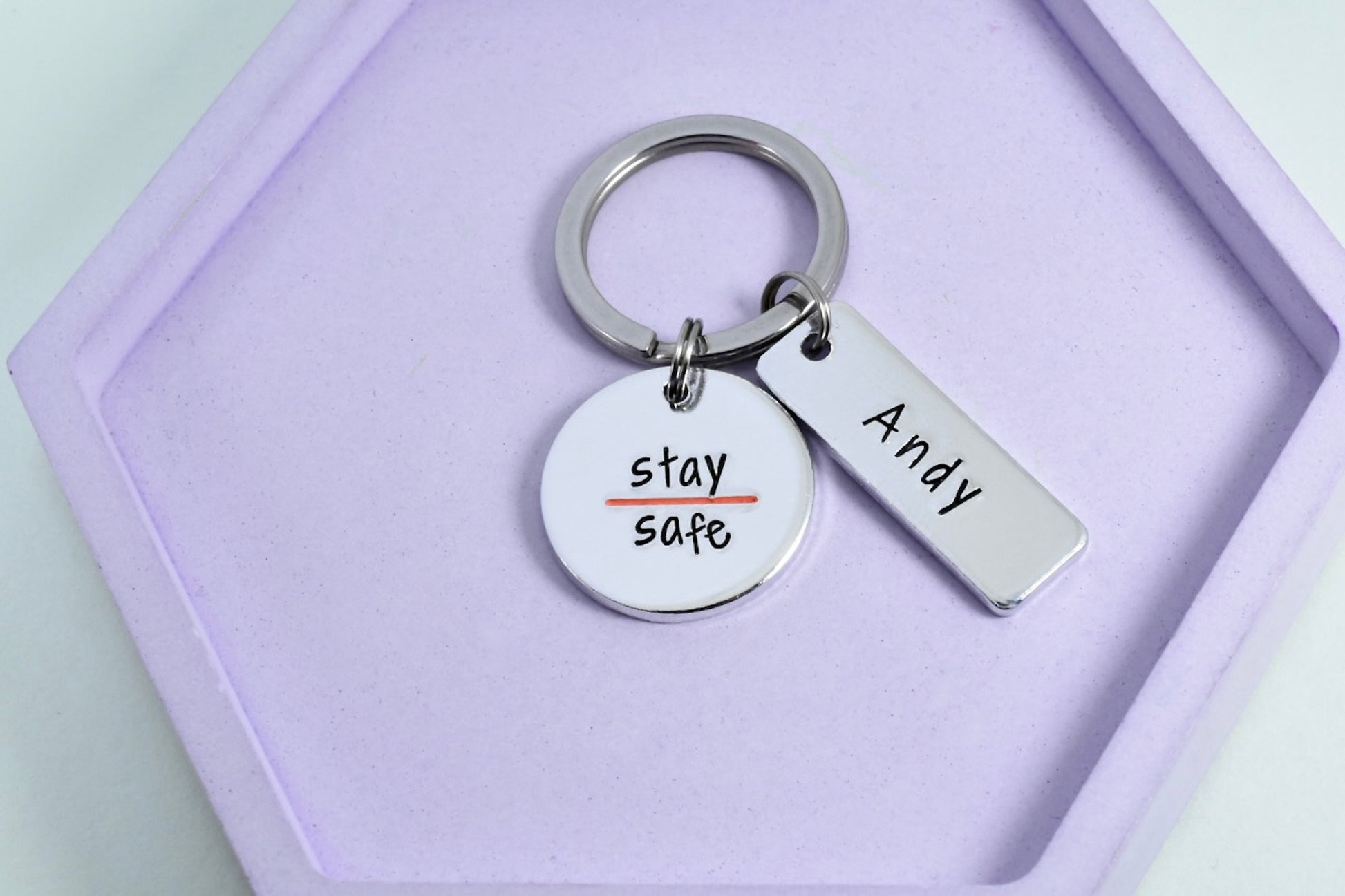 A personalised Search and Rescue Worker keyring with a stamped disc and a thin orange line, with the text 'STAY SAFE' and a name 'Andy'.