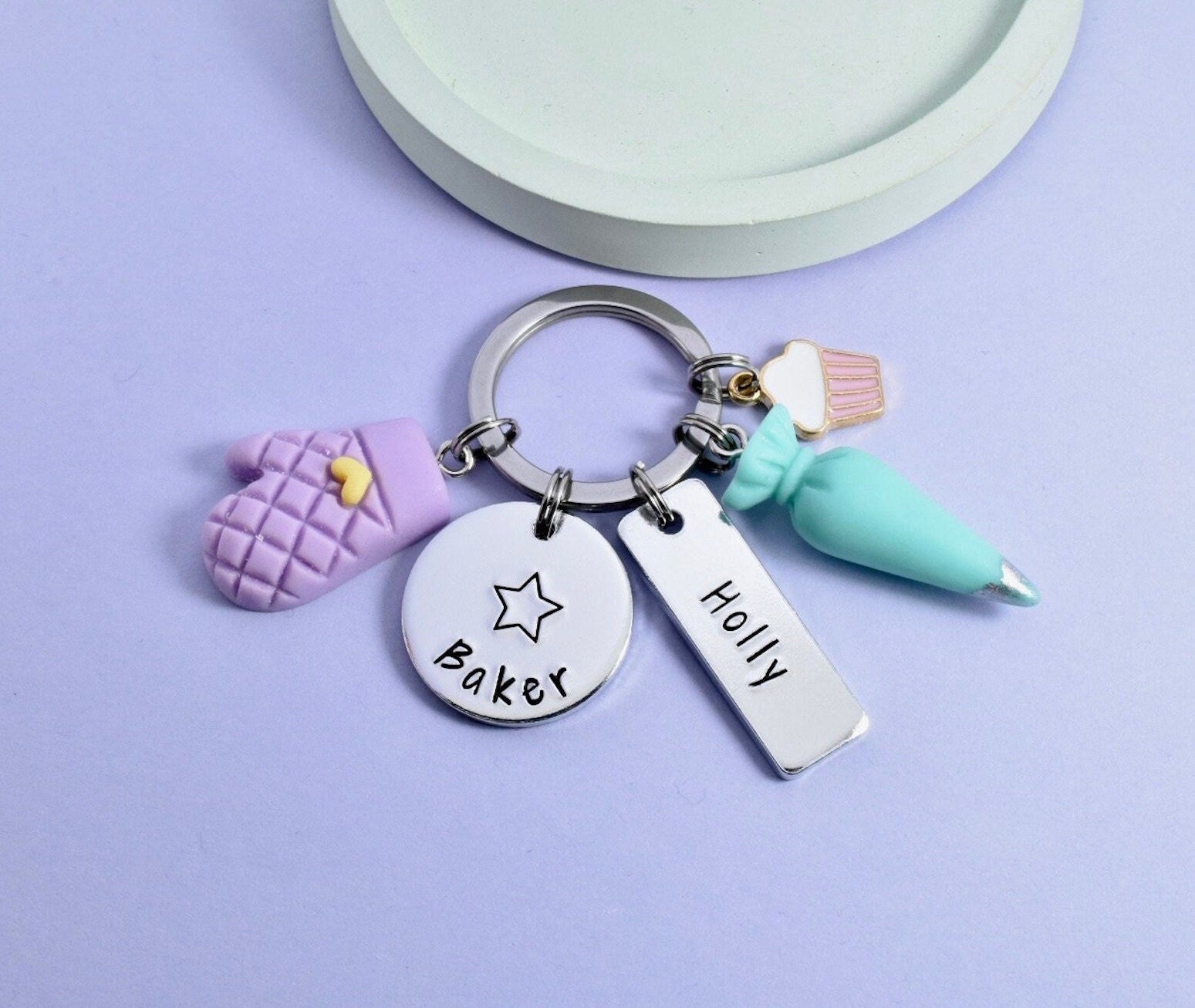 silver aluminium star baker keyring, personalised rectangle with baker design charms like over mitt, piping bag and cupcake charms
